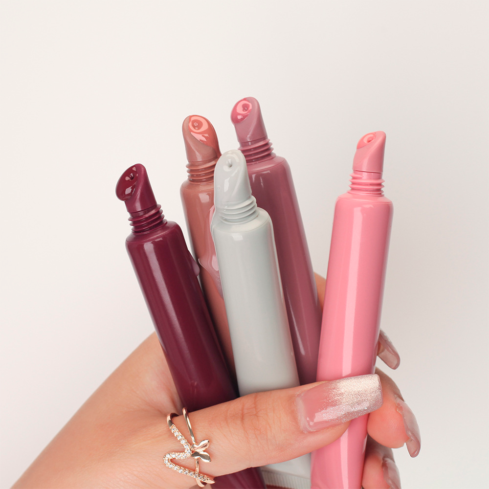 Hand holding four ELIL Peptide Tinted Lip Balm tubes in different shades, a fun makeup gift for teens
