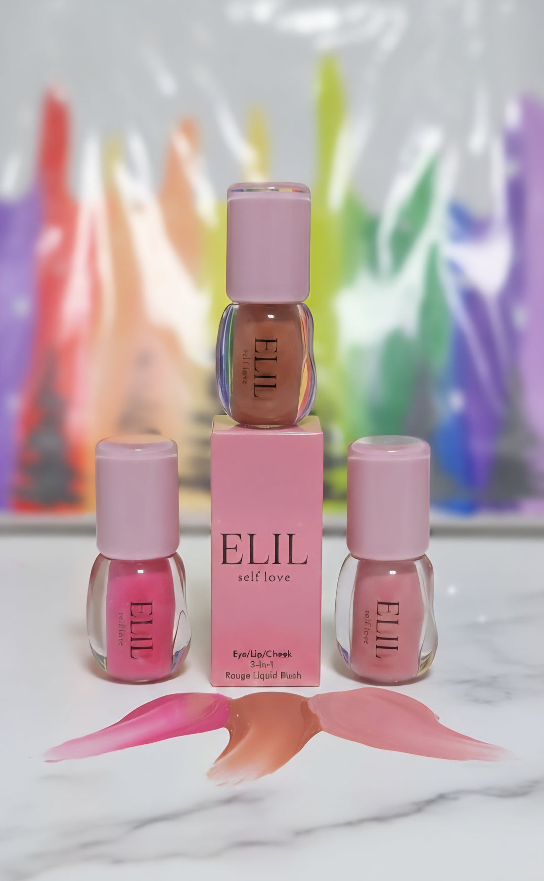 Three ELIL 3 in 1 C.E.L liquid blush bottles with box and color swatches for cheeks, eyes and lips